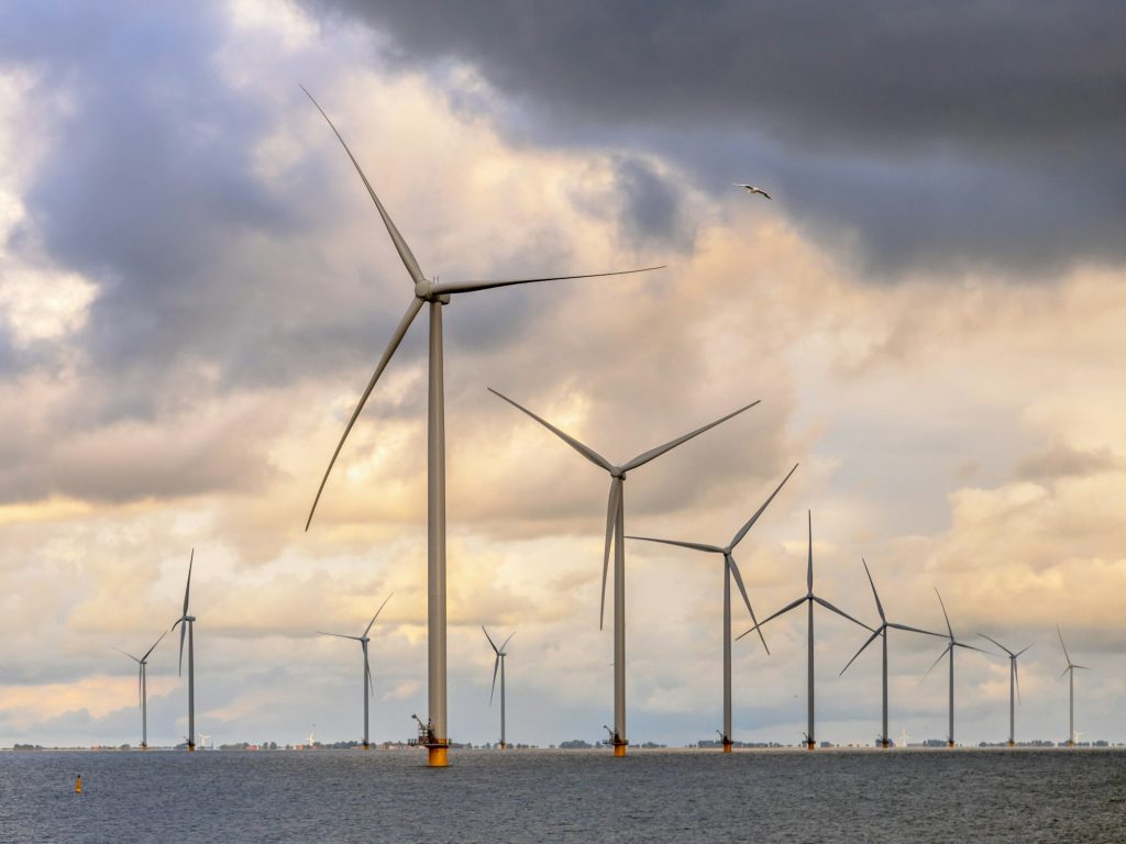 Offshore Windfarm at sea under cloudy sky